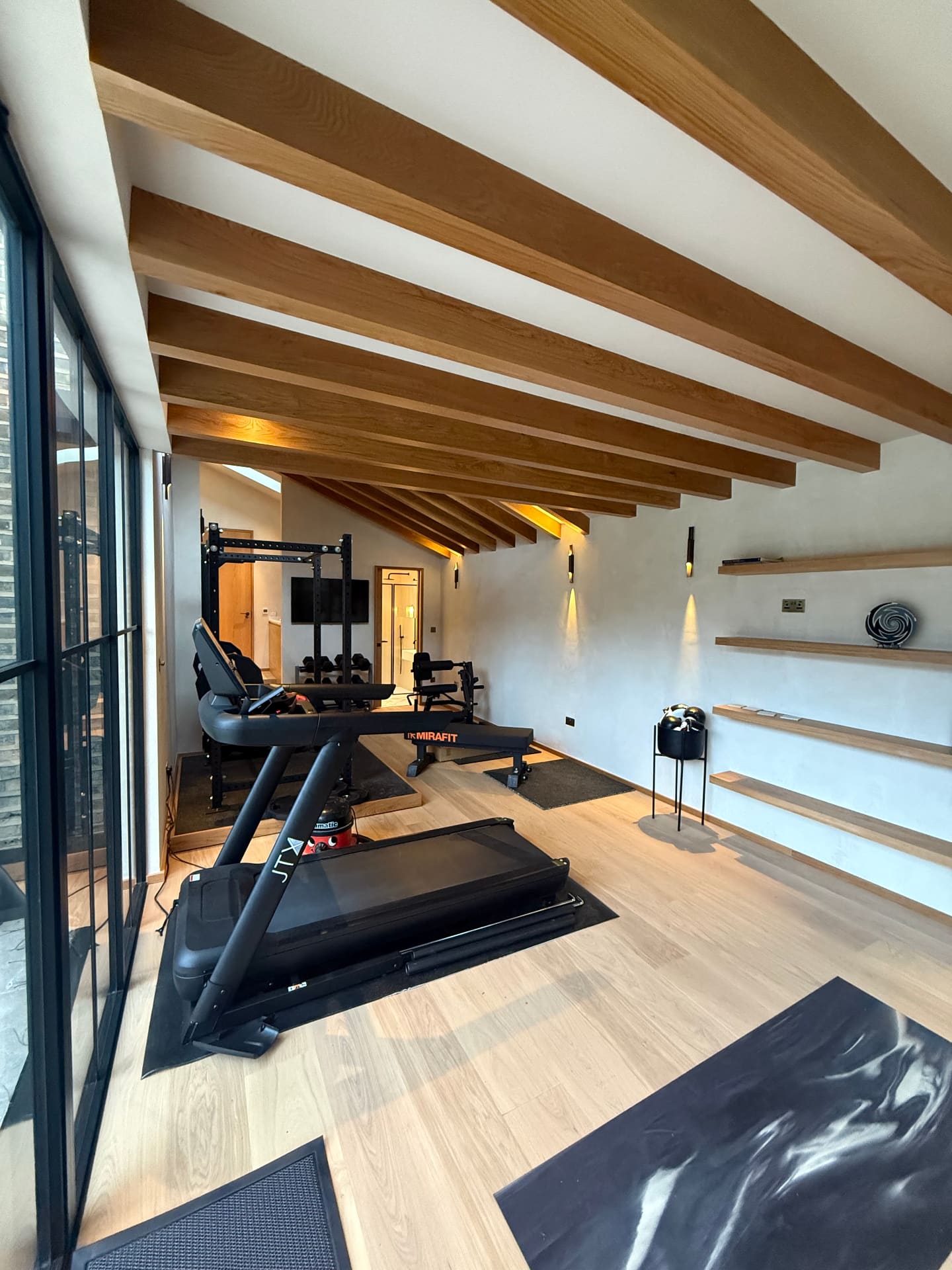 High-end London loft conversion with Velux windows, premium finishes and exposed timber beams